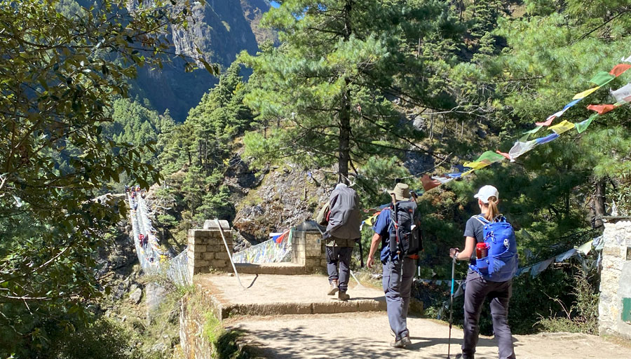 trek from Phakding to Namche involves a steady climb through dense forests, crossing suspension bridges, and offering stunning views of snow-capped peaks,