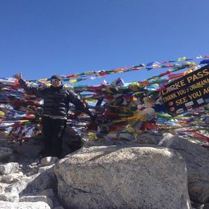 Man standing at Manaslu Larkya pass trek highest point at Larkya pass.